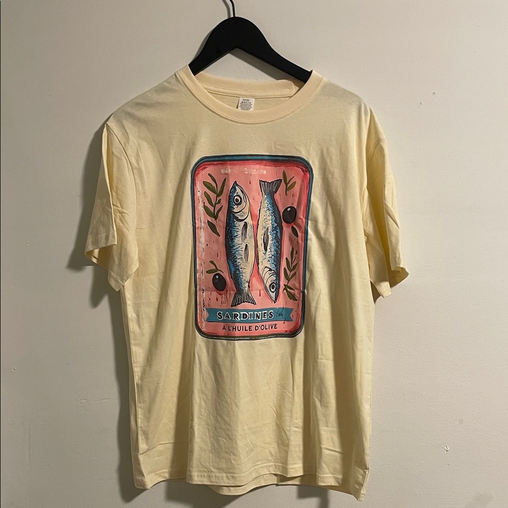 Amazon Cream T-Shirt with Pink Sardine Graphic